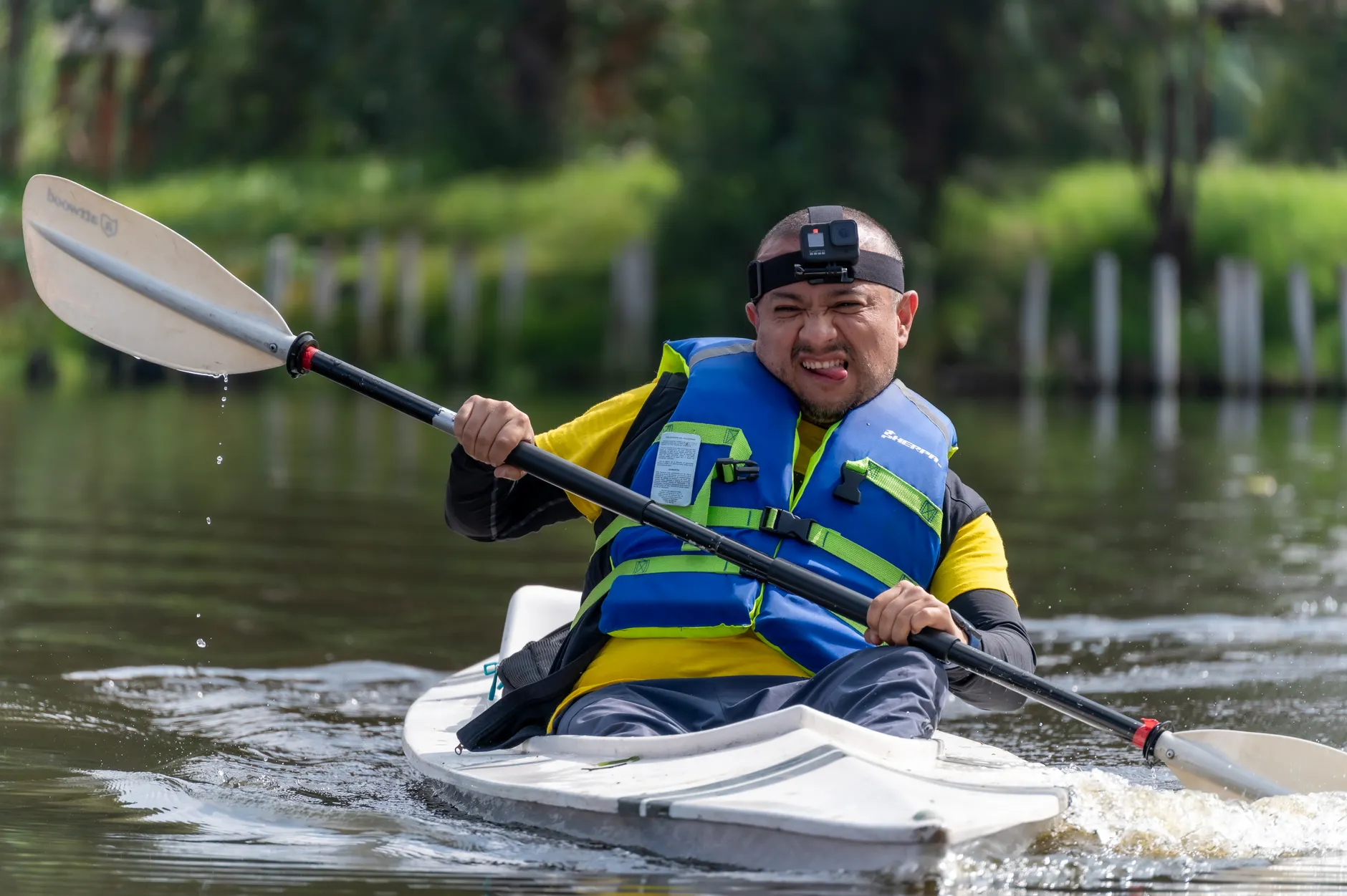 Man enjoying kayaking on a calm river in Mexico, showcasing adventure and outdoor fun.